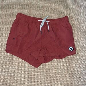 Brick colored Vuori workout shorts